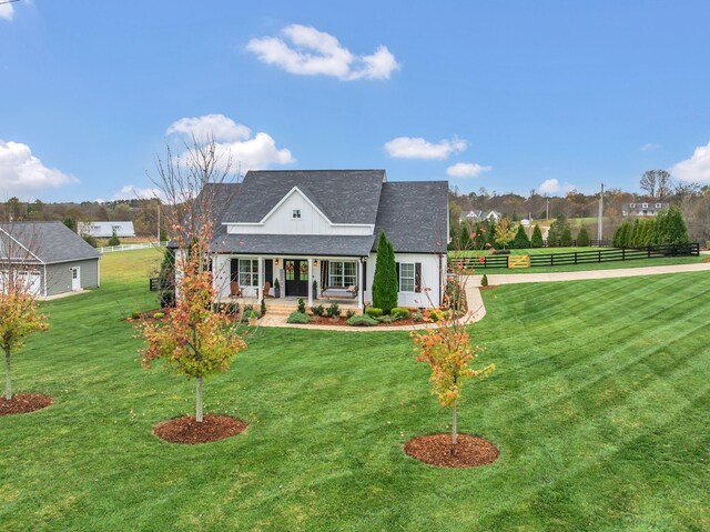 new england style home featuring a front lawn and a porch