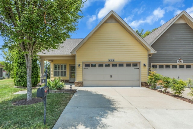 view of front of home featuring a garage and a front yard