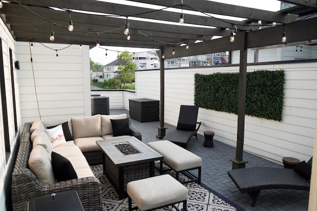 view of patio / terrace featuring a pergola and an outdoor living space with a fire pit