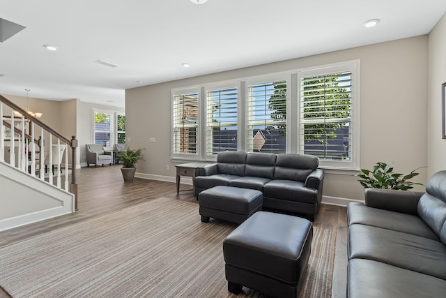 living room featuring hardwood / wood-style flooring and an inviting chandelier