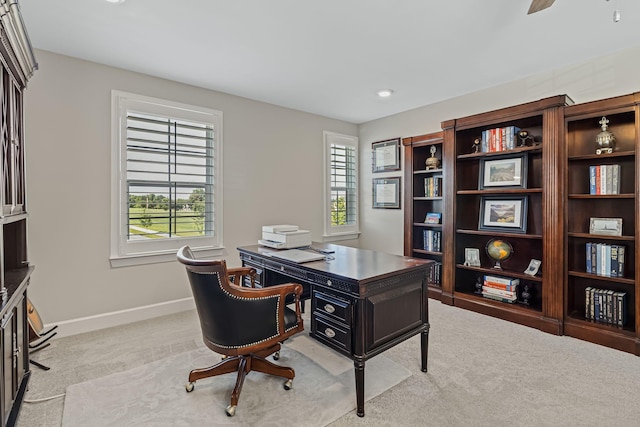 carpeted home office with ceiling fan