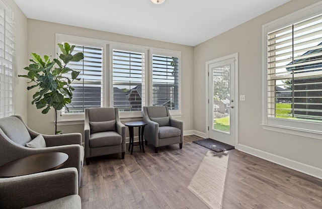 sitting room with plenty of natural light and wood-type flooring