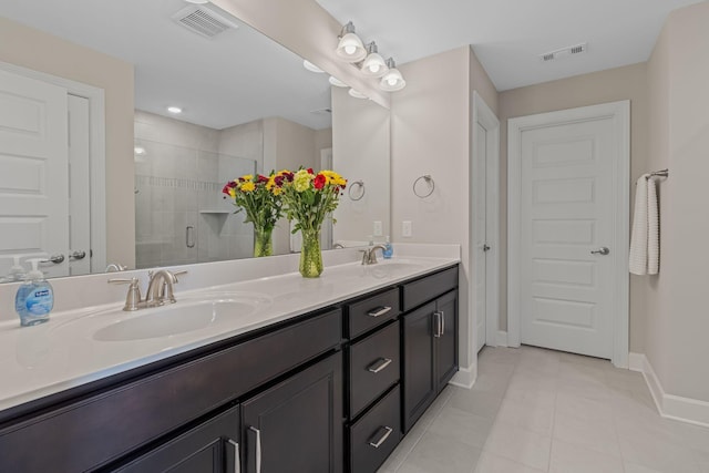 bathroom featuring tile patterned flooring, vanity, and walk in shower