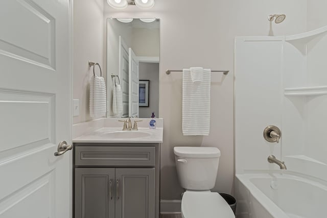 full bathroom with vanity, tiled shower / bath combo, and toilet