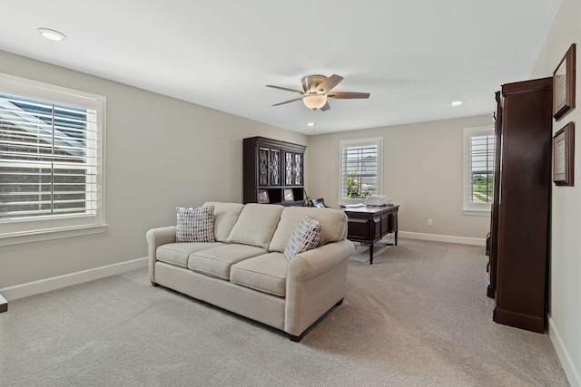 living room featuring ceiling fan and light colored carpet