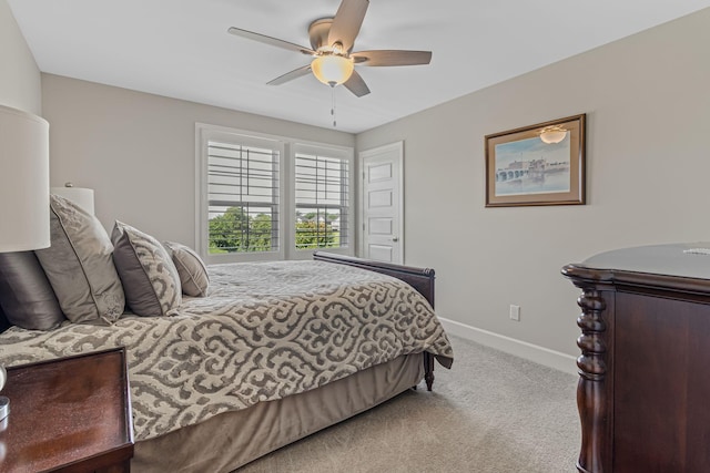 bedroom featuring light carpet and ceiling fan