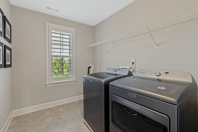 laundry room featuring separate washer and dryer