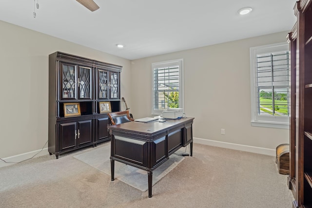 office space featuring ceiling fan and light colored carpet