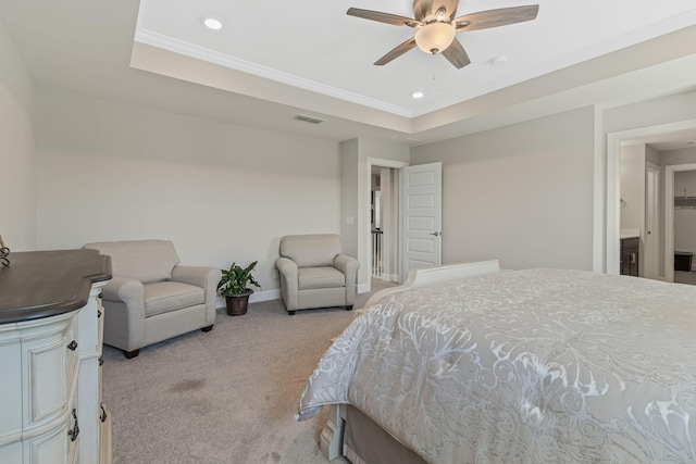 carpeted bedroom featuring ceiling fan, ornamental molding, and a tray ceiling