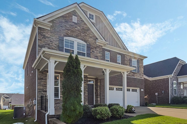 view of front facade with central AC, a front yard, and a garage