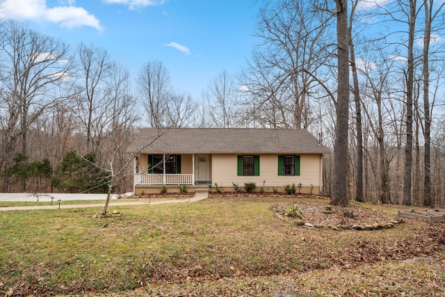 ranch-style home featuring covered porch and a front yard