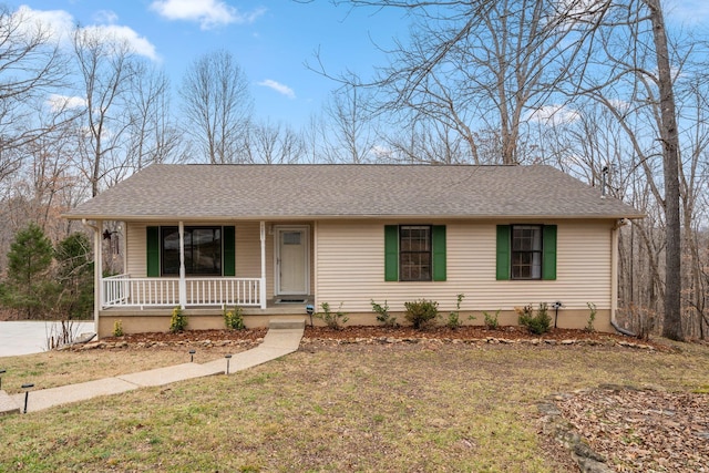 ranch-style house with covered porch and a front yard