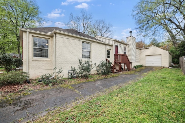 3417 Pleasant Valley Rd, Nashville, TN 37204 - view of front of house with a garage, an outdoor structure, and a front lawn