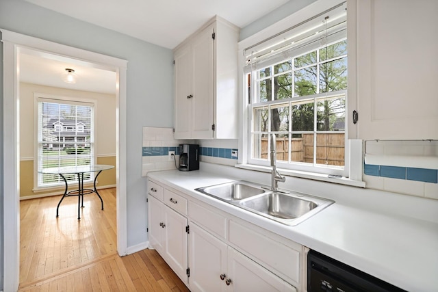 3417 Pleasant Valley Rd, Nashville, TN 37204 - kitchen featuring decorative backsplash, black dishwasher, white cabinetry, and sink