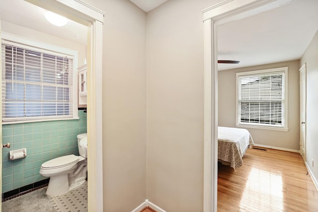 3417 Pleasant Valley Rd, Nashville, TN 37204 - bathroom featuring hardwood / wood-style floors, ceiling fan, toilet, and tile walls