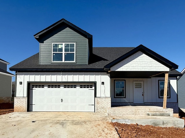 view of front of property with driveway, board and batten siding, and brick siding