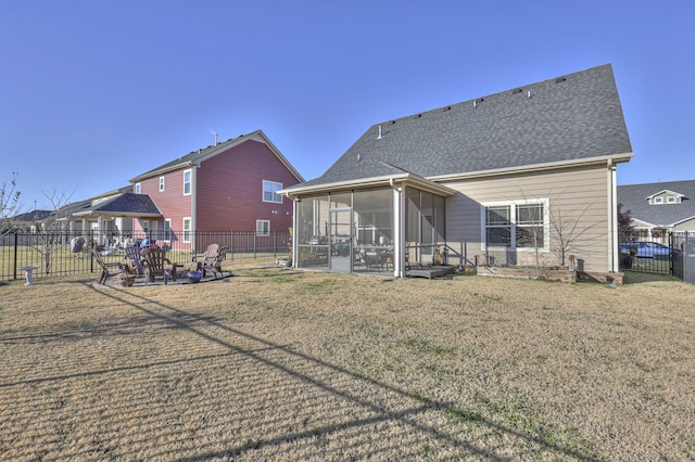 rear view of property featuring a sunroom and a yard