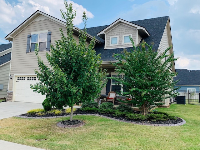 view of front facade with central AC unit, a garage, and a front lawn