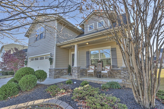 view of front of house featuring covered porch and a garage