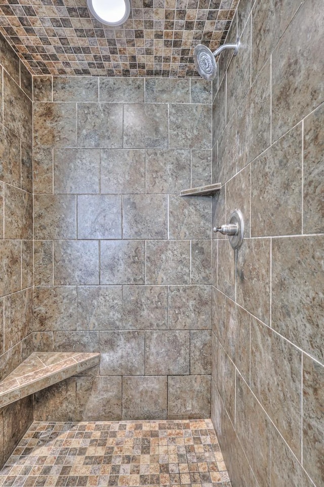 bathroom with tiled shower