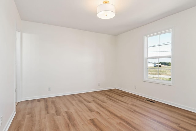 spare room with light hardwood / wood-style floors