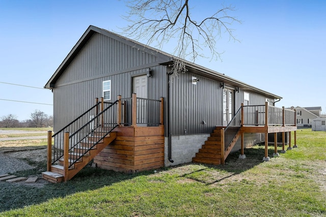 back of house with a lawn and a deck