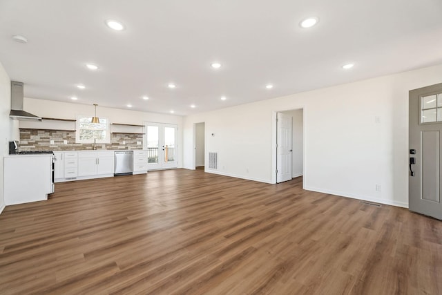 unfurnished living room featuring sink and dark wood-type flooring