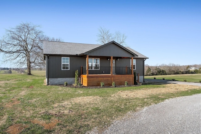 view of front of house with covered porch and a front yard