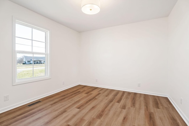 spare room featuring light wood-type flooring