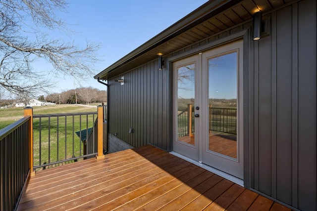 wooden deck with french doors and a yard