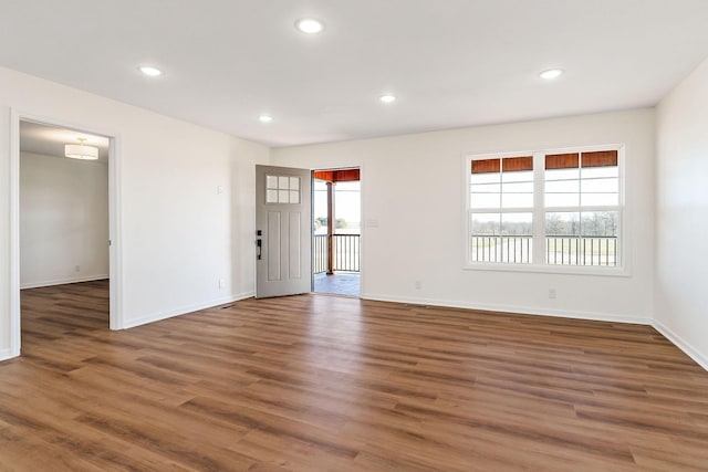 unfurnished room featuring dark hardwood / wood-style flooring