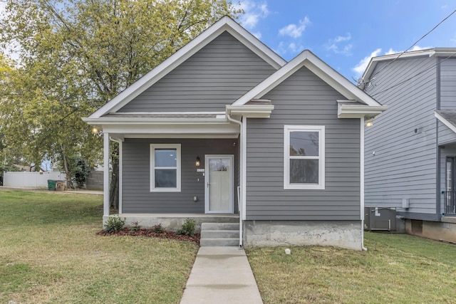 bungalow-style home featuring central AC and a front yard