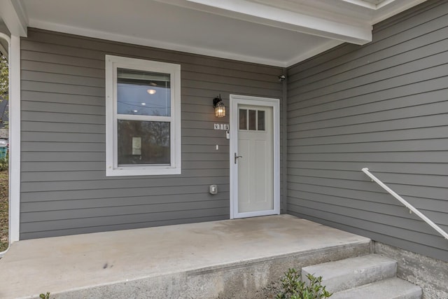 view of exterior entry with a porch