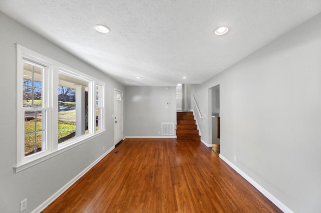 interior space featuring wood-type flooring and a textured ceiling