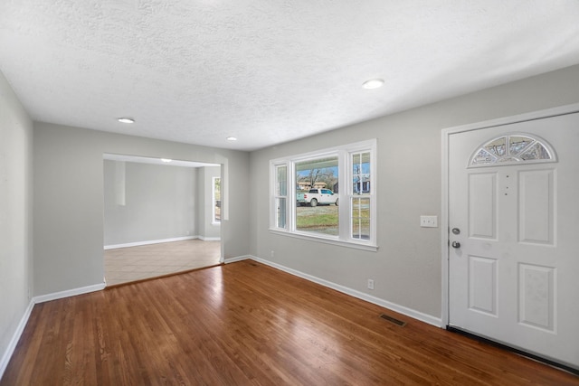 entryway featuring hardwood / wood-style floors and a textured ceiling