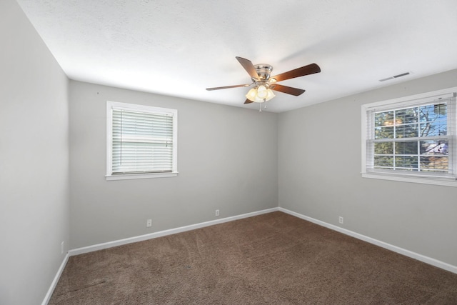 carpeted spare room featuring ceiling fan