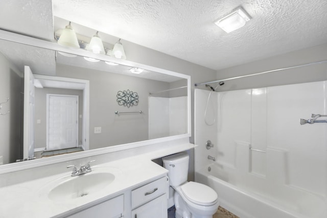 full bathroom featuring bathing tub / shower combination, vanity, a textured ceiling, and toilet