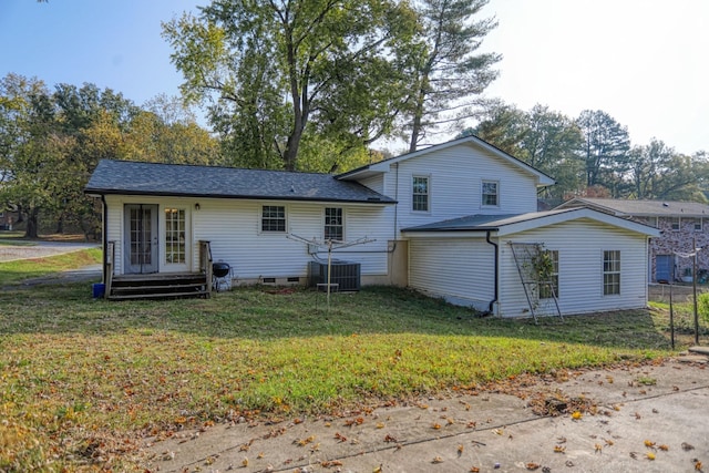 rear view of house featuring a yard