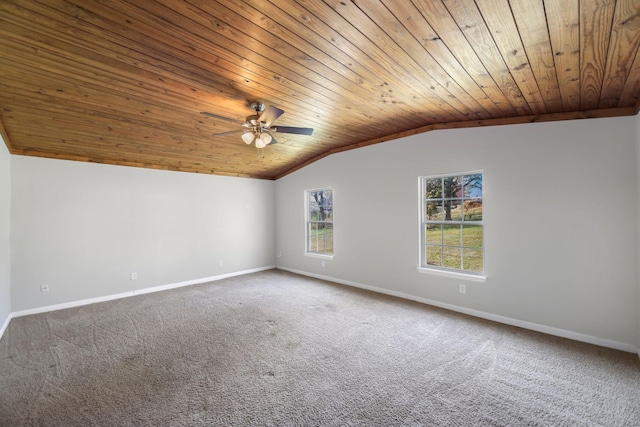 carpeted spare room featuring ceiling fan, wood ceiling, and vaulted ceiling