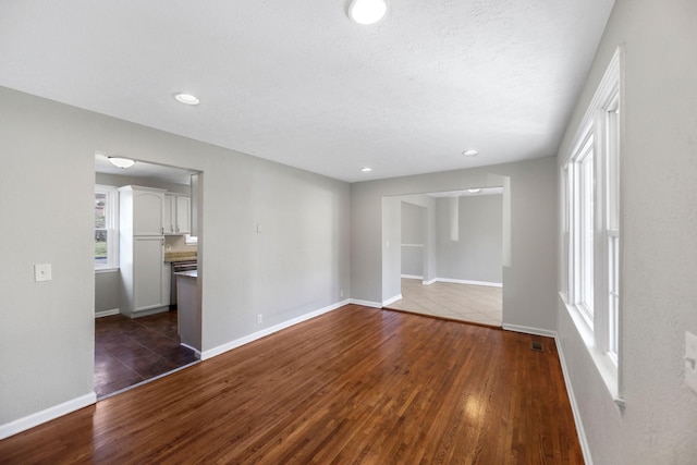 unfurnished room with dark hardwood / wood-style floors