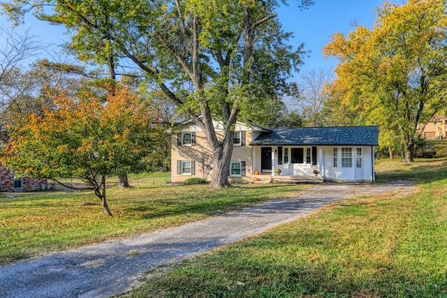 tri-level home with a front lawn