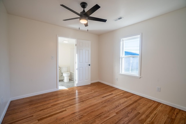 unfurnished bedroom featuring ceiling fan, light hardwood / wood-style flooring, and ensuite bathroom