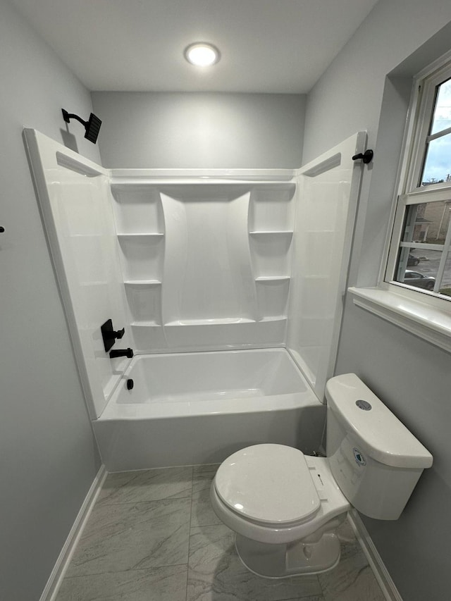 bathroom featuring toilet and tub / shower combination