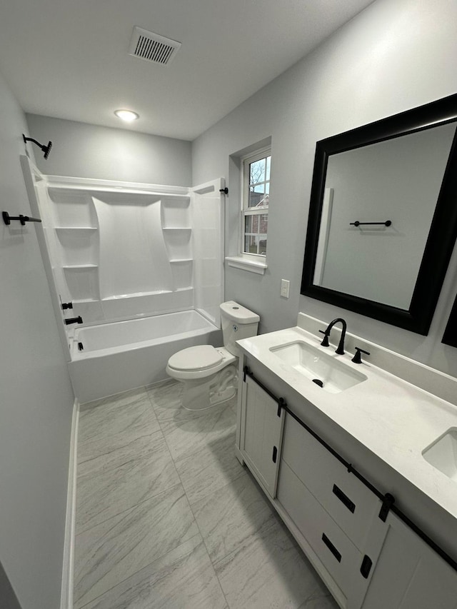 full bathroom featuring vanity, bathtub / shower combination, and toilet