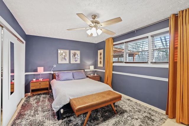 bedroom with ceiling fan, carpet floors, a textured ceiling, and a closet