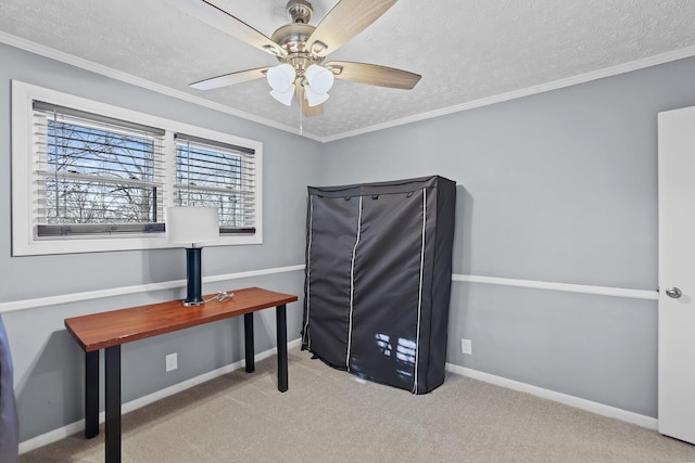 home office featuring a textured ceiling, light colored carpet, ceiling fan, and ornamental molding