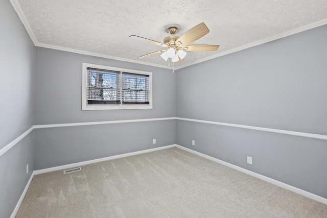 unfurnished room with a textured ceiling, light colored carpet, and ornamental molding