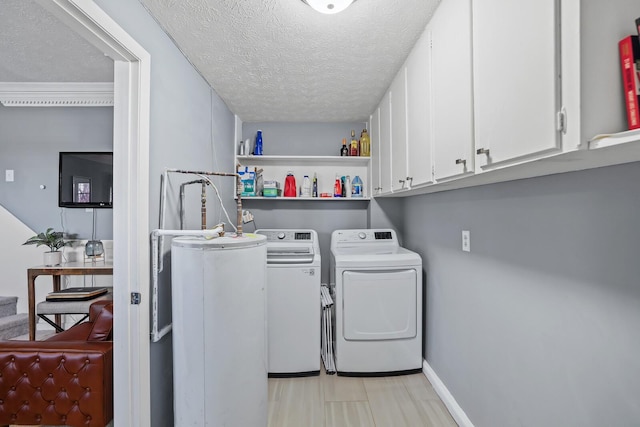 laundry area featuring cabinets, independent washer and dryer, and a textured ceiling