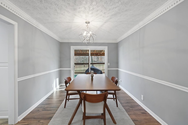 dining space featuring a notable chandelier, dark hardwood / wood-style floors, crown molding, and a textured ceiling