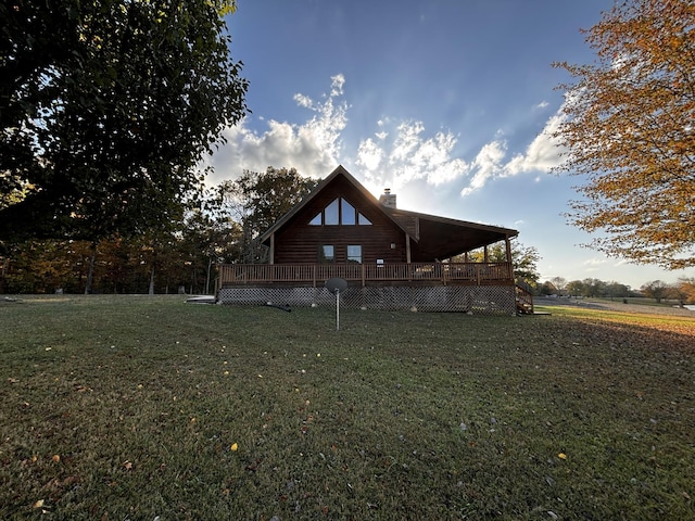 back of house with a lawn and a deck